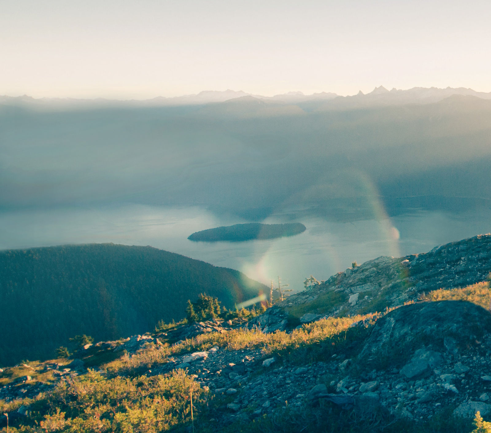 Mountain view overlooking a lake and sun beams