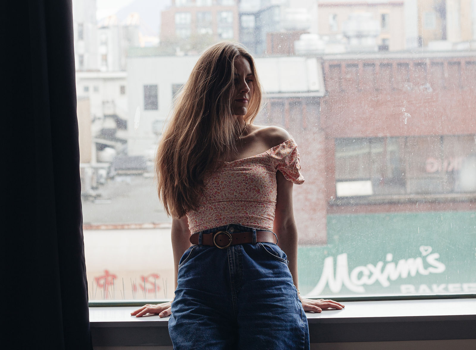 woman standing at big window