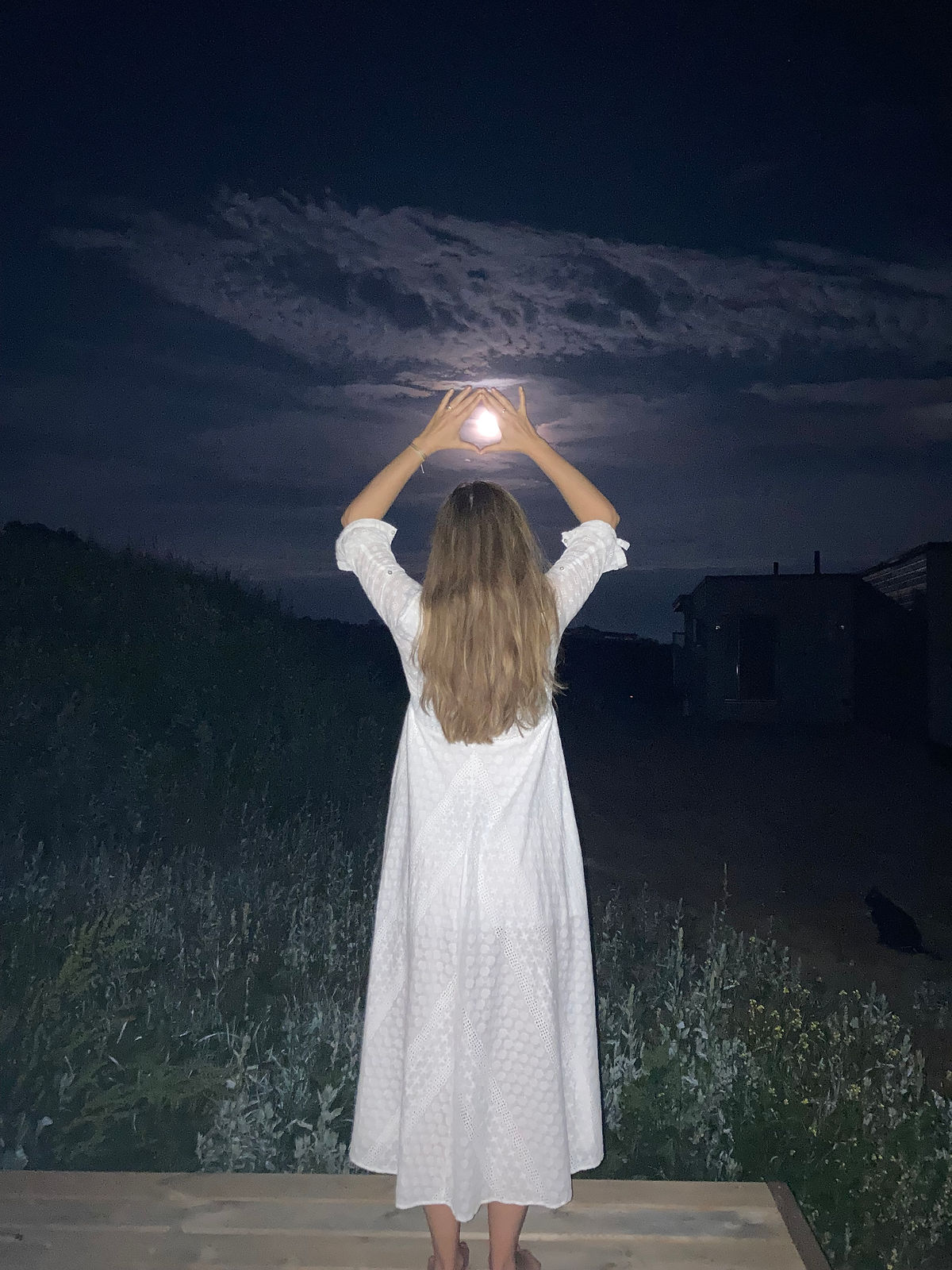 Woman embracing full moon