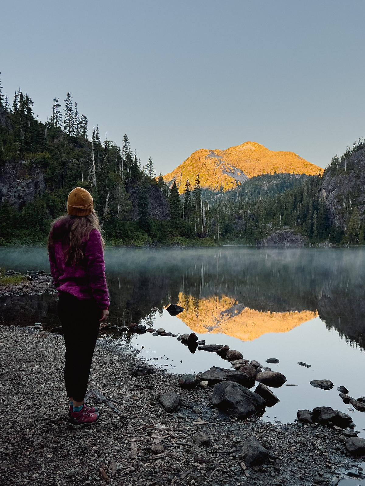 Woman in front of mountain lake