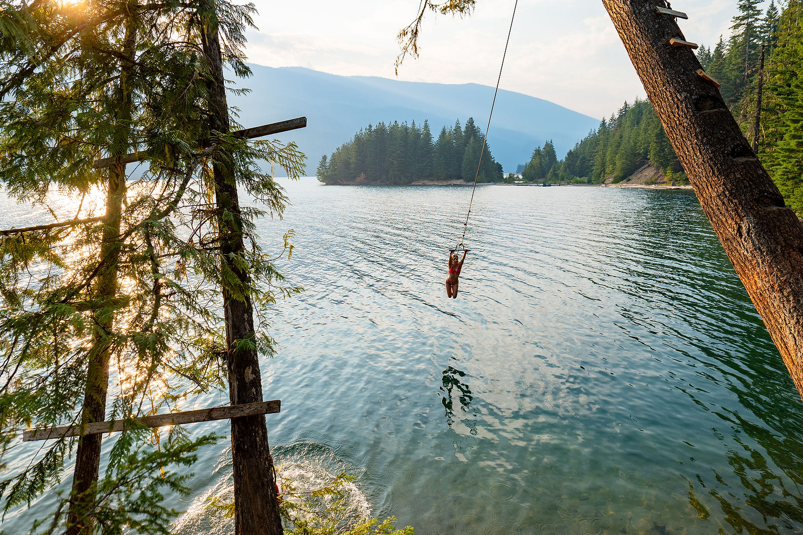Gils on a swing in the water