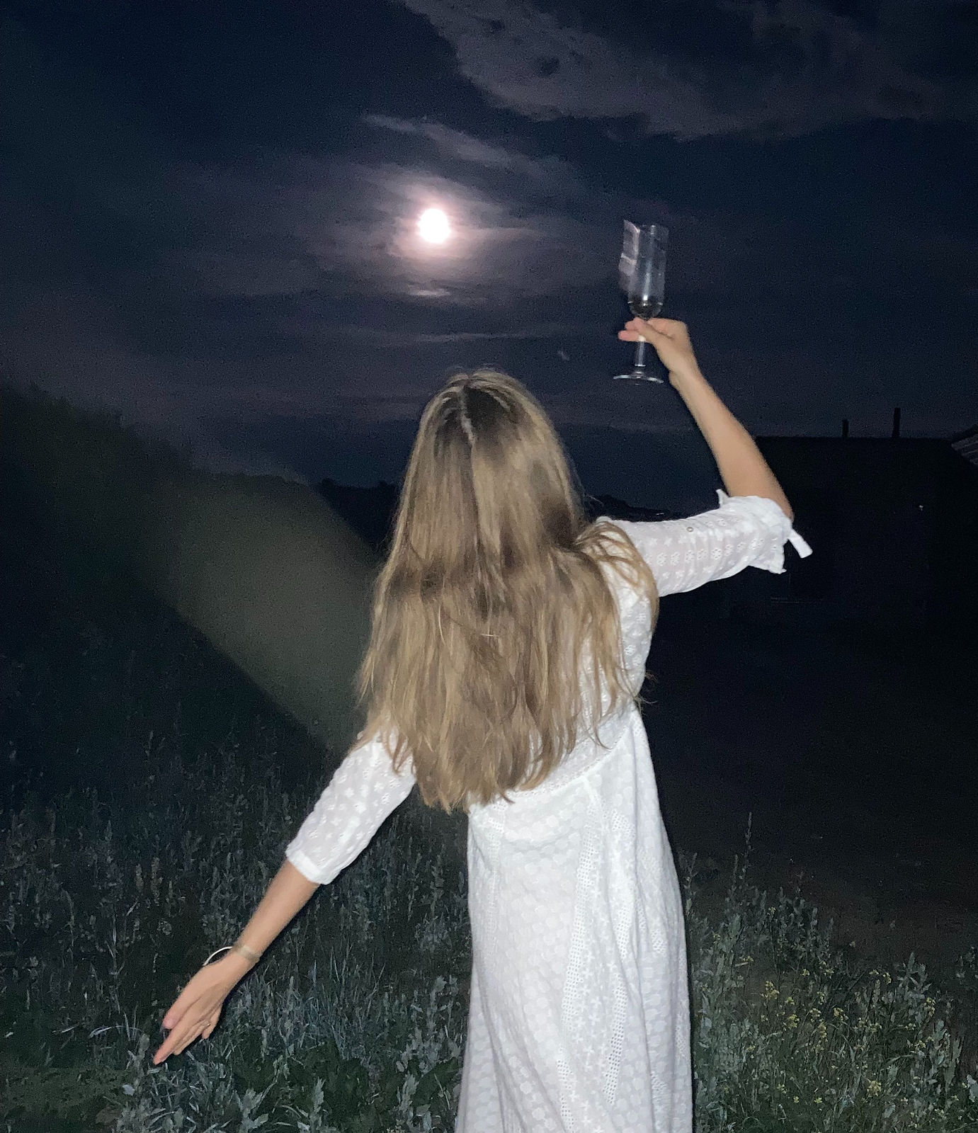 Woman embracing full moon