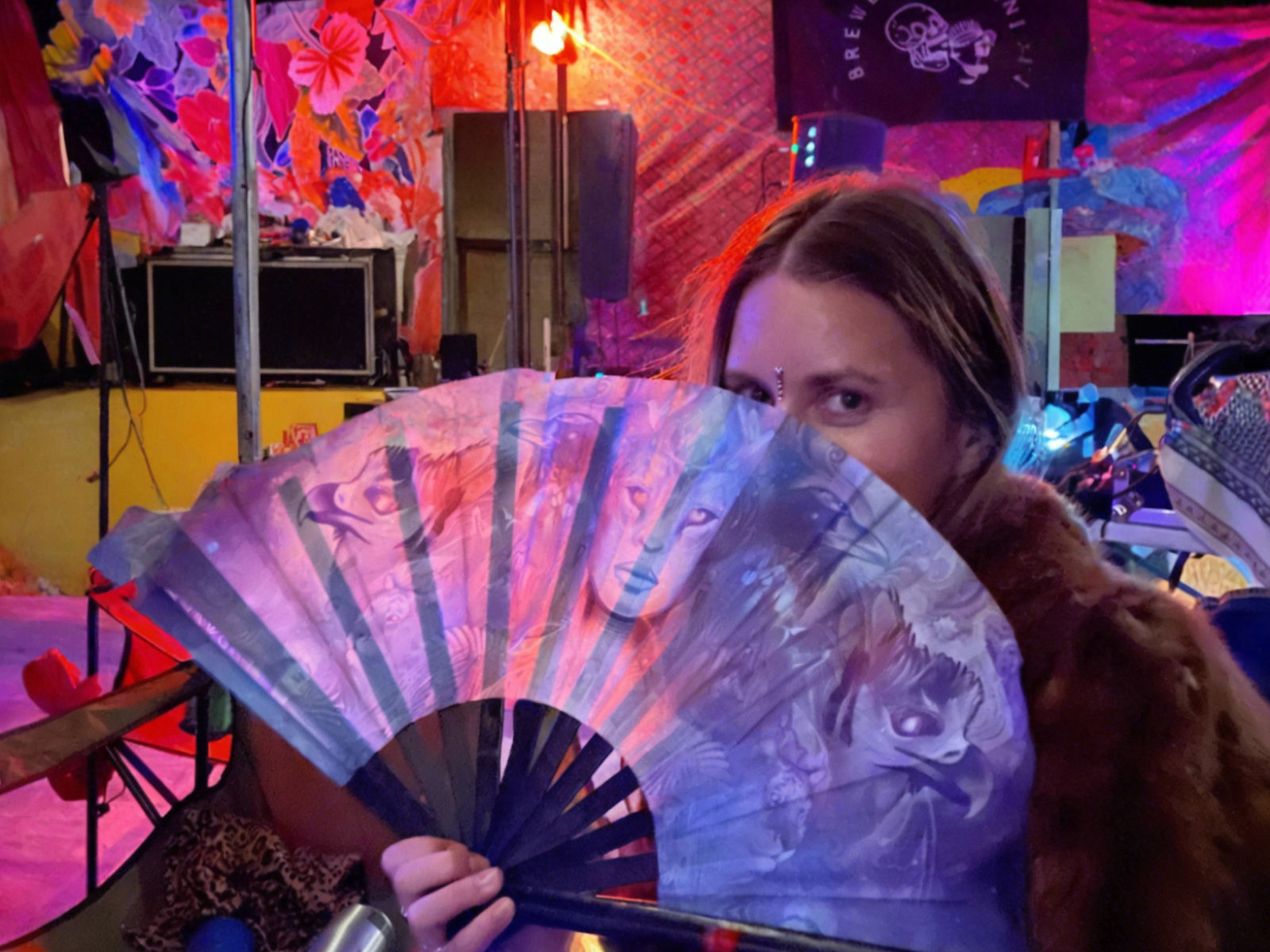 Woman hides behind a fan